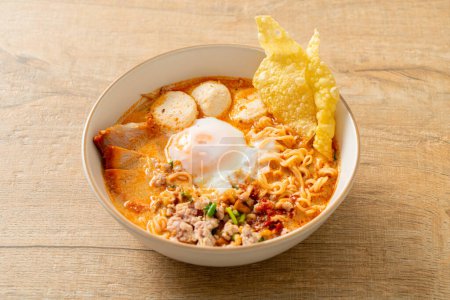 instant noodles with pork and meatballs in spicy soup or Tom Yum Noodles in Asian style