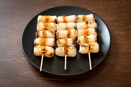 grilled tube shaped fish paste cake or tube squid skewer on plate