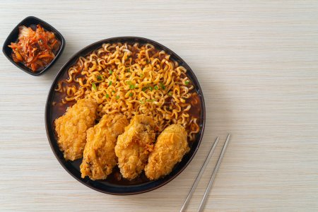 Korean instant noodles with fried chicken or Fried chicken ramyeon - Korean food style