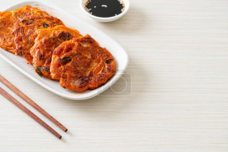 Photo for Korean Kimchi pancake or Kimchijeon - Fried Mixed Egg, Kimchi, and Flour - Korean traditional food style - Royalty Free Image