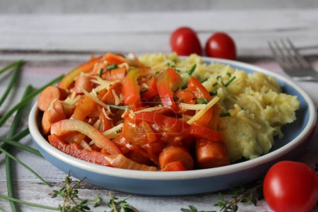 Comfort Fusion: Cheesy Mashed Potato Sausage Stew with Vibrant Bell Peppers, Tomatoes, and Fresh Thyme