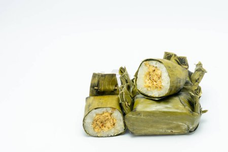 Indonesian tradisional food called lemper made from steamed glutinous rice with chicken floss wrapped in banana leaves.