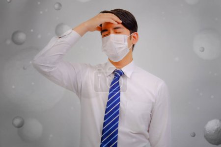 Photo for Asian man wear masks to protect PM 2.5 dust and air pollution and headache and sickness, air pollution concept, healthcare concept. - Royalty Free Image