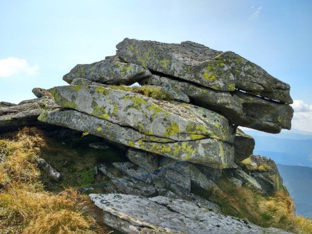 Rock formation on a tourist mountain route against the sky. The diversity of the Ukrainian Carpathians