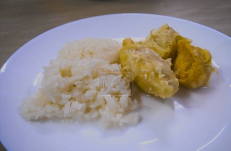 Appetizing durian dessert with sticky rice mixed in coconut milk.