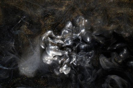 Golden sparkling abstract background, luxury black smoke, acrylic paint underwater explosion, cosmic swirling ink Poster 617881474