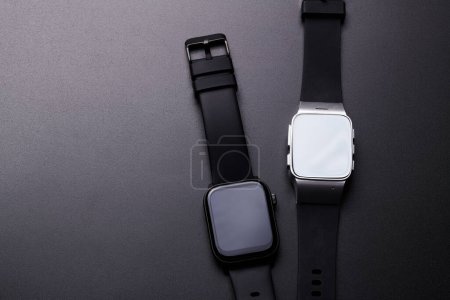 Photo for Wireless electronic smart watch with Touch Screen close-up isolated on black background. Bluetooth Bracelet, black band fitness tracker - Royalty Free Image