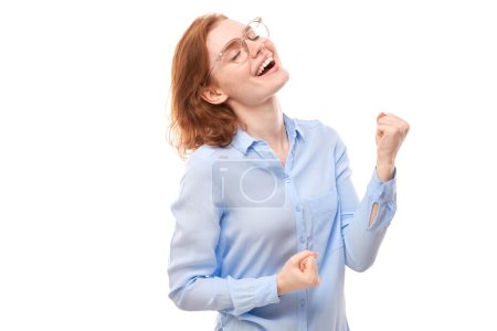 Photo for Portrait of positive redhead girl in business shirt emotionally rejoices and feels happy isolated on white background, advertising banner - Royalty Free Image
