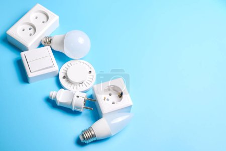 Photo for Electric light set with dimmer switch, controllable lighting. Saving energy concept, device designed to change electrical power isolated on blue background - Royalty Free Image