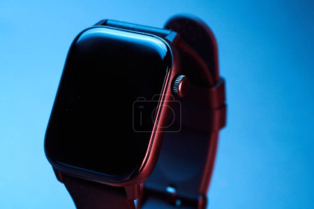 Photo for Wireless electronic smart watch with Touch Screen close-up isolated on blue background. Bluetooth Bracelet, black band fitness tracker - Royalty Free Image