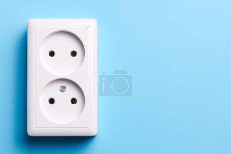 Photo for White double socket isolated on blue background. Electric lighting concept - Royalty Free Image