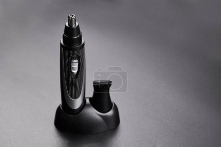 Photo for Nose and ear hair removal trimmer, men's electric razor close-up isolated on black background - Royalty Free Image
