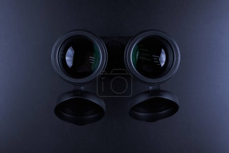 Photo for New binoculars isolated on black background. Flat lay, top view - Royalty Free Image