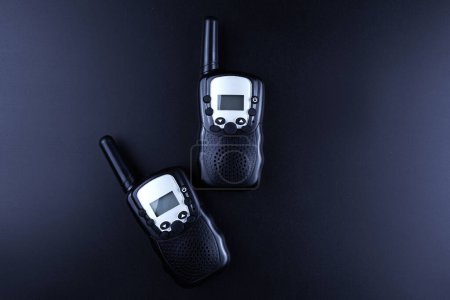 Photo for Black rectangle portable device with antenna isolated on black background. radio transceiver set for communication. radio set, walkie-talkie - Royalty Free Image