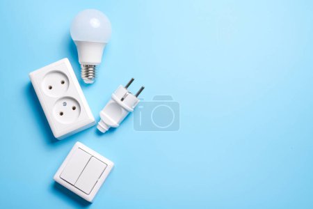 Photo for Electric light set with dimmer switch, controllable lighting. Saving energy concept, device designed to change electrical power isolated on blue background - Royalty Free Image