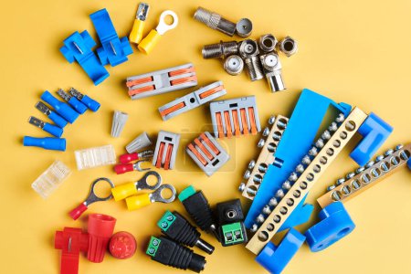 Photo for Different electrical tools isolated on yellow background, electrician equipment, wires, terminals, connectors, fuses, switches - Royalty Free Image