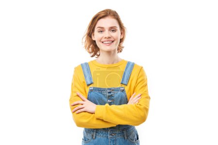 Photo for Portrait of attractive red-haired girl in yellow casual smiling joyfully isolated on white studio background - Royalty Free Image