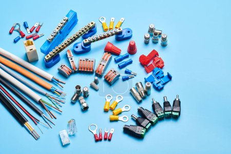 Photo for Different electrical tools isolated on blue background, electrician equipment, wires, terminals, connectors, fuses, switches - Royalty Free Image