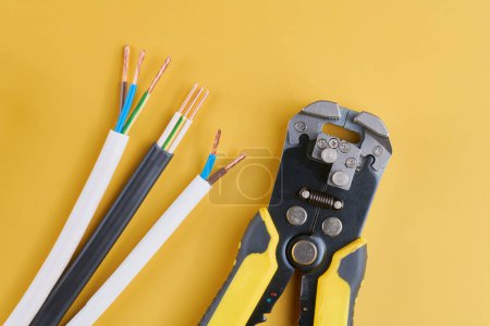 Photo for Cable stripping and crimping tool, Wire strippers isolated on yellow background - Royalty Free Image