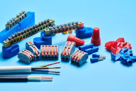 Photo for Different electrical tools isolated on blue background, electrician equipment, wires, terminals, connectors, fuses, switches - Royalty Free Image