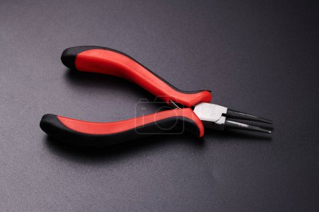 Photo for Pliers isolated on black background. Hand tool for repair, construction and maintenance - Royalty Free Image