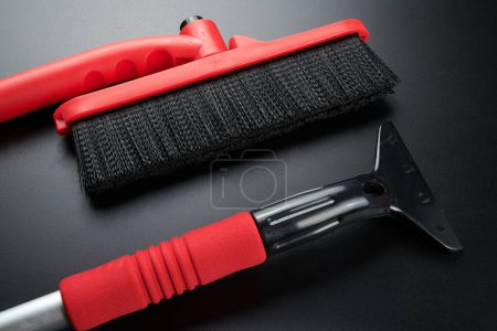 Photo for Car scraper brush to clean snow from windshield, remove ice isolated on black background - Royalty Free Image