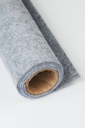 Foto de Soft felt textile material gray color, colorful texture fabric roll closeup - Imagen libre de derechos