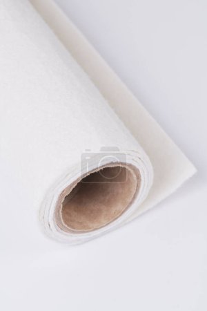 Foto de Soft felt textile material of beige color, colorful texture fabric roll closeup - Imagen libre de derechos