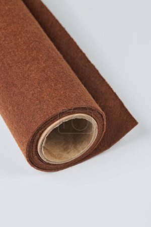 Foto de Soft felt textile material brown colors, colorful texture fabric roll closeup - Imagen libre de derechos
