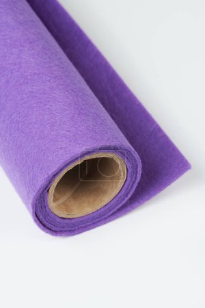 Foto de Soft felt textile material lilac colors, colorful texture fabric roll closeup - Imagen libre de derechos