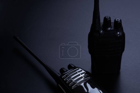 Photo for Black rectangle portable device with antenna isolated on black background. radio transceiver set for communication. radio set, walkie-talkie - Royalty Free Image
