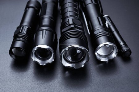 Photo for Set of black pocket tactical flashlights isolated on black background - Royalty Free Image