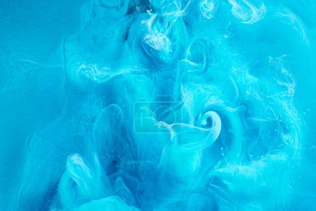 Photo for Blue abstract ocean background. Splashes and waves of paint under water, clouds of smoke in motion. - Royalty Free Image