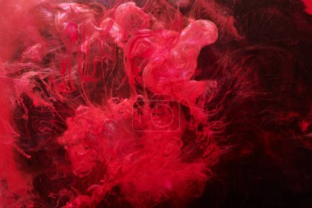 Photo for Red abstract ocean background. Splashes and waves of paint under water, clouds of smoke in motion. - Royalty Free Image