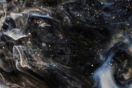 Photo for Black gold abstract ocean background. Splashes and waves of sparkling paint under water, clouds of interstellar smoke in motion - Royalty Free Image