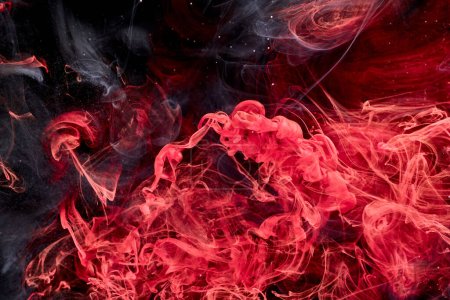 Red black abstract ocean background. Splashes and waves of paint under water, clouds of smoke in motion
