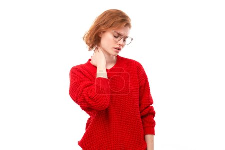 Photo for Portrait redhead young woman with suffering face feels pain in her neck isolated on white studio background - Royalty Free Image