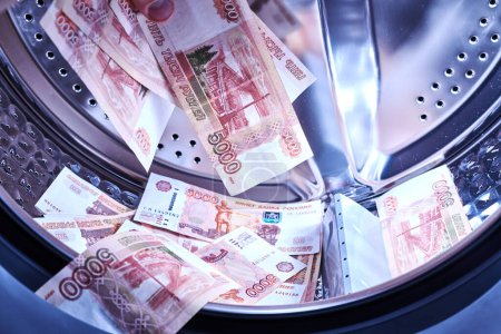 Photo for Russian banknotes in the washing machine. Money laundering, financial fraud concept - Royalty Free Image