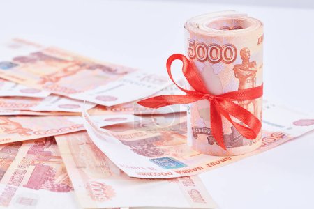 Photo for Russian rubles five thousand banknotes, bundle of money with red ribbon on white background, gift concept - Royalty Free Image