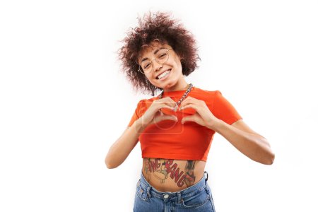 Photo for Portrait happy young brunette curly woman makes heart gesture, asks to be my valentine. Girlfriend keep hands on chest, feel thankful isolated on white studio background - Royalty Free Image