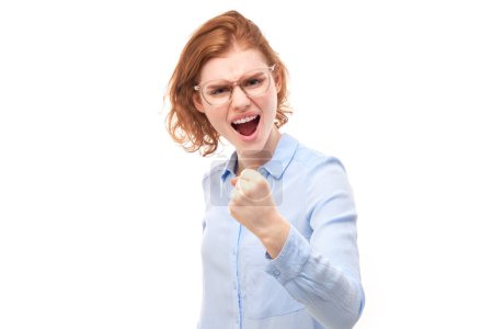 Photo for Portrait angry redhead young woman screaming isolated on white studio background, showing negative emotion - Royalty Free Image