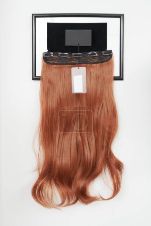 Photo for Natural looking wig brown color in beauty salon, hair on shelf in wig shop - Royalty Free Image