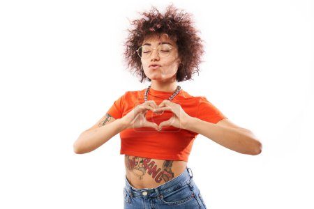 Photo for Portrait happy young brunette curly woman makes heart gesture, asks to be my valentine. Girlfriend keep hands on chest, feel thankful isolated on white studio background - Royalty Free Image