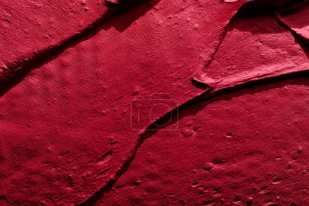 Photo for Decorative red putty background. Wall texture with filler paste applied with spatula, chaotic dashes and strokes over plaster. Creative design, stone pattern, cemen - Royalty Free Image