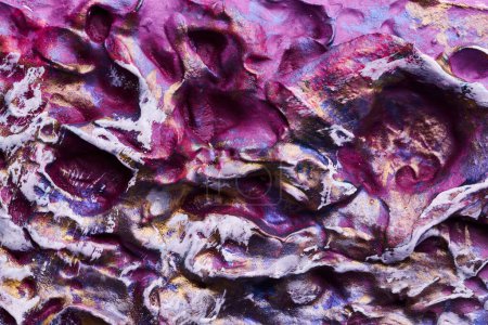 Téléchargez les photos : Décoratif violet fond de mastic d'or. Texture murale avec de la pâte de remplissage appliquée avec une spatule, des tirets chaotiques et des traits sur du plâtre. Conception créative, motif en pierre, hommes - en image libre de droit