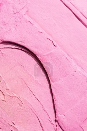 Photo for Decorative pink putty background. Wall texture with filler paste applied with spatula, chaotic dashes and strokes over plaster. Creative design, stone pattern, cemen - Royalty Free Image