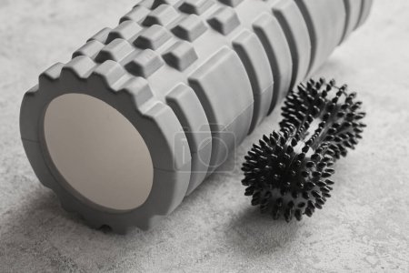 Photo for Gray foam roller and black ball for relaxing muscle massage isolated on white background. Myofascial release concept. Sports and recovery, yoga, self-massag - Royalty Free Image