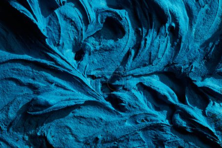 Photo for Decorative blue putty background. Wall texture with filler paste applied with spatula, chaotic dashes and strokes over plaster. Creative design, stone pattern, cemen - Royalty Free Image