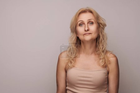 Photo for Beautiful blond middle aged woman smiling face looking camera portrait. Elegant mature lady no makeup 50 years old close-up isolated on white Women's health, cosmetology, skin care - Royalty Free Image
