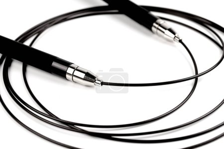 Photo for Black fitness skipping rope close-up isolated on white gray background. sports equipment - Royalty Free Image